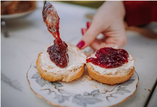 Freshly baked scones with clotted cream and strawberry jam served at afternoon tea in Essex