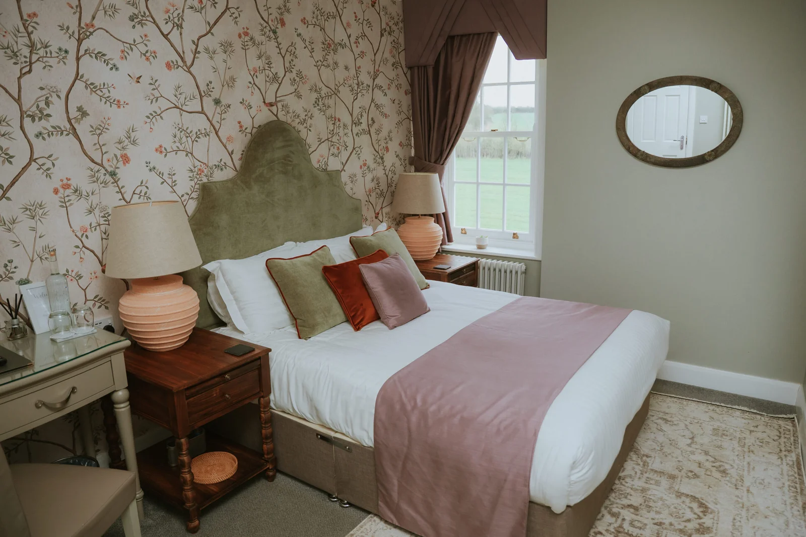 Elegant boutique bedroom at Downham Hall Essex with floral wallpaper and king size bed