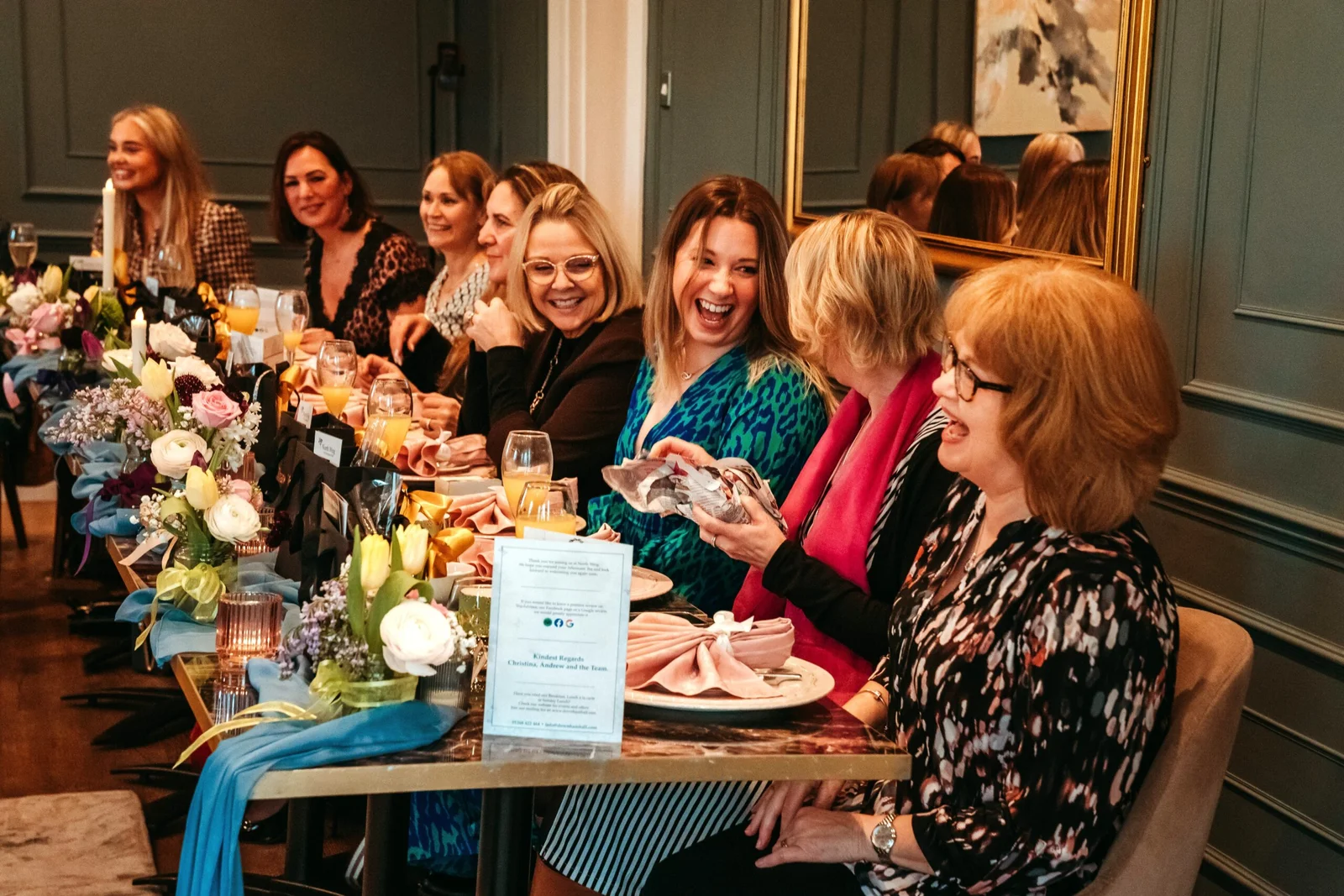 A group of guests enjoying a private dinner party in the elegant De Beauvoir Suite at Downham Hall.