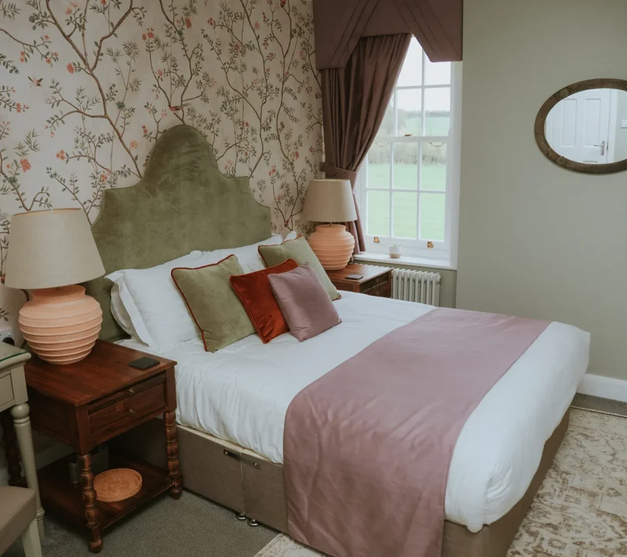 Boutique countryside bedroom at Downham Hall Essex with elegant decor and soft furnishings